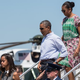 President Barack Obama (center), first lady Michelle Obama and daughter Malia arrive at Cape Cod Coast Guard Air Station in Massachusetts on Aug. 9, 2014, before departing for their vacation at Martha's Vineyard.
NICHOLAS KAMM/AFP/Getty Images